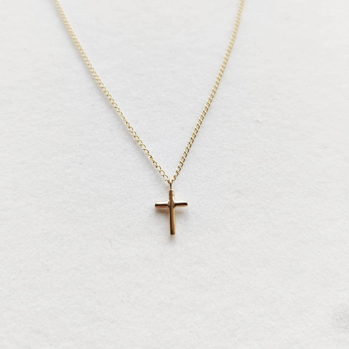 Petite cross necklace in 9ct gold