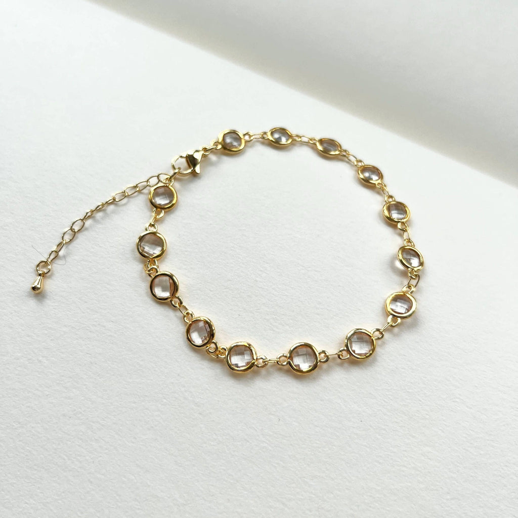 Gold filled crystal charm bracelet laid flat with extender chain