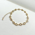 Gold filled crystal charm bracelet laid flat with extender chain