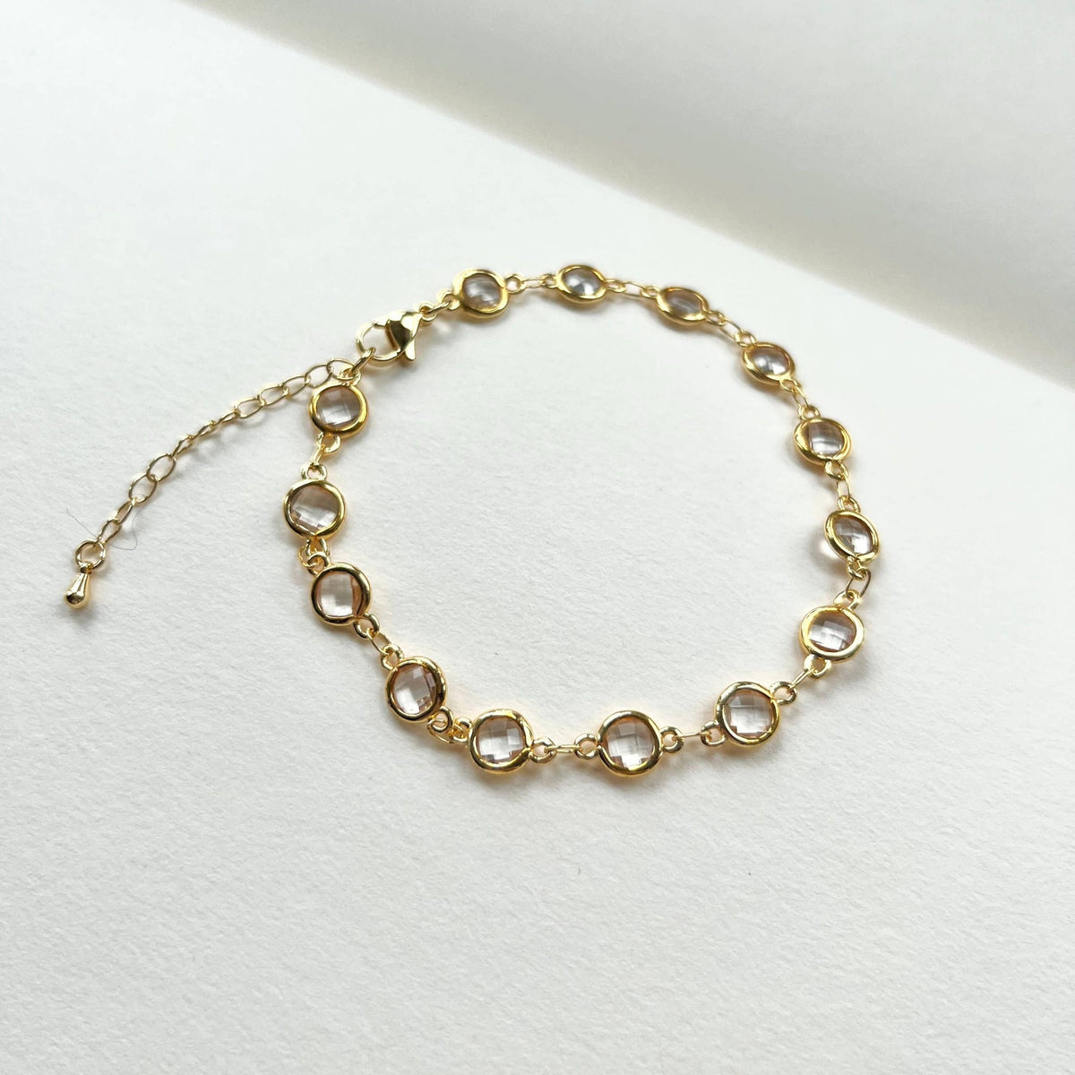 Gold filled crystal charm bracelet laid flat with extender chain