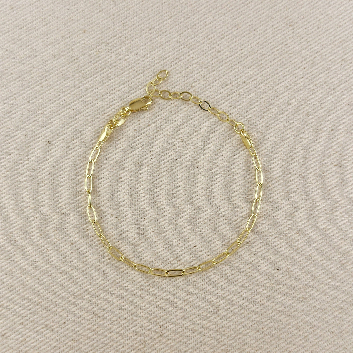 Gold filled paperclip link chain bracelet on linen