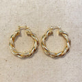 Gold filled twisted tube hoop earrings on linen