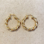 Gold filled twisted tube hoop earrings on linen