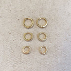 Pavé hoop earring trio in three sizes laid out on linen