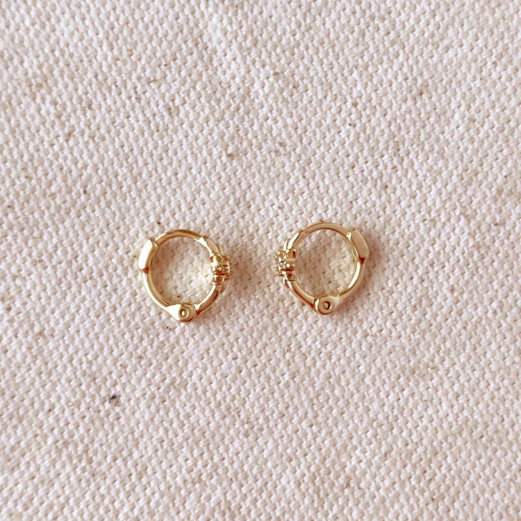 Starburst mini huggie hoops in gold filled on linen