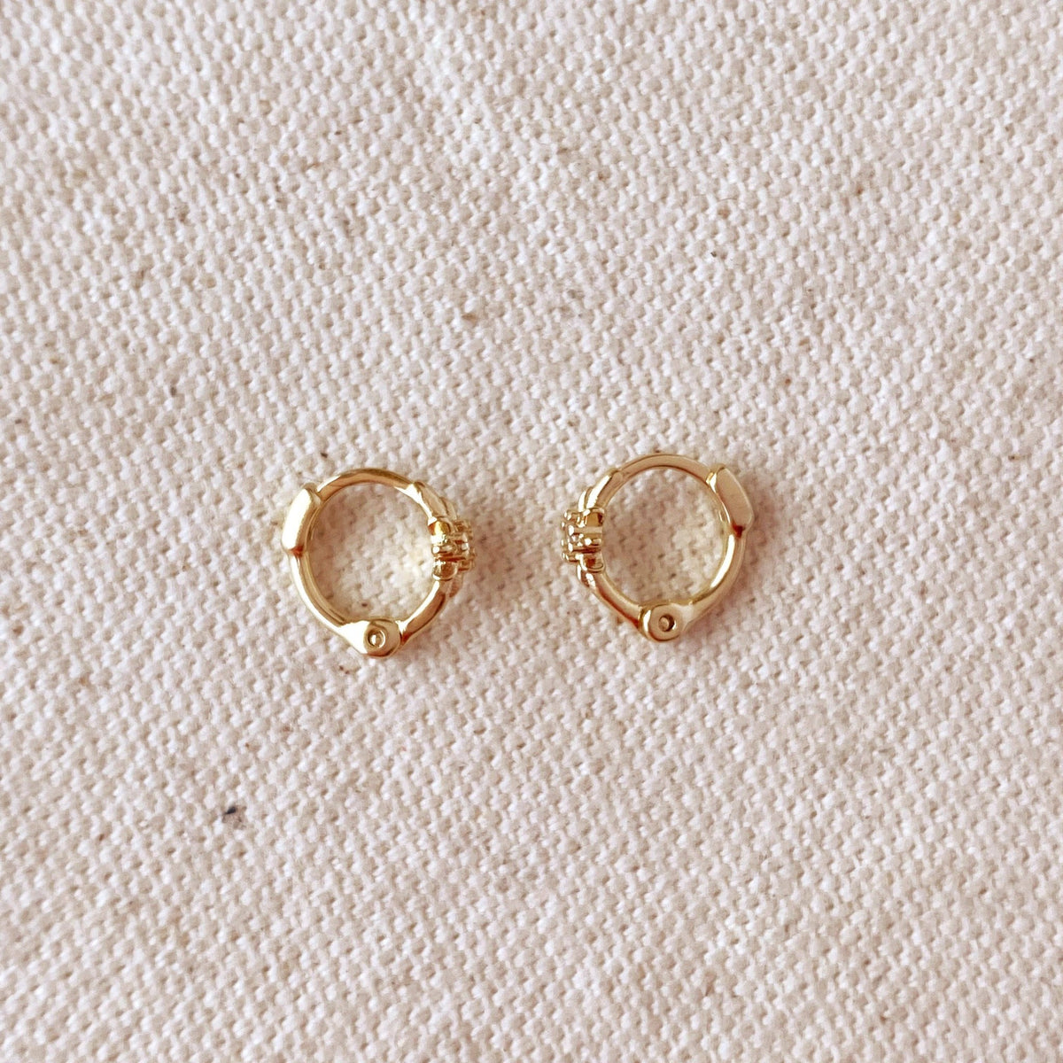 Starburst mini huggie hoops in gold filled on linen