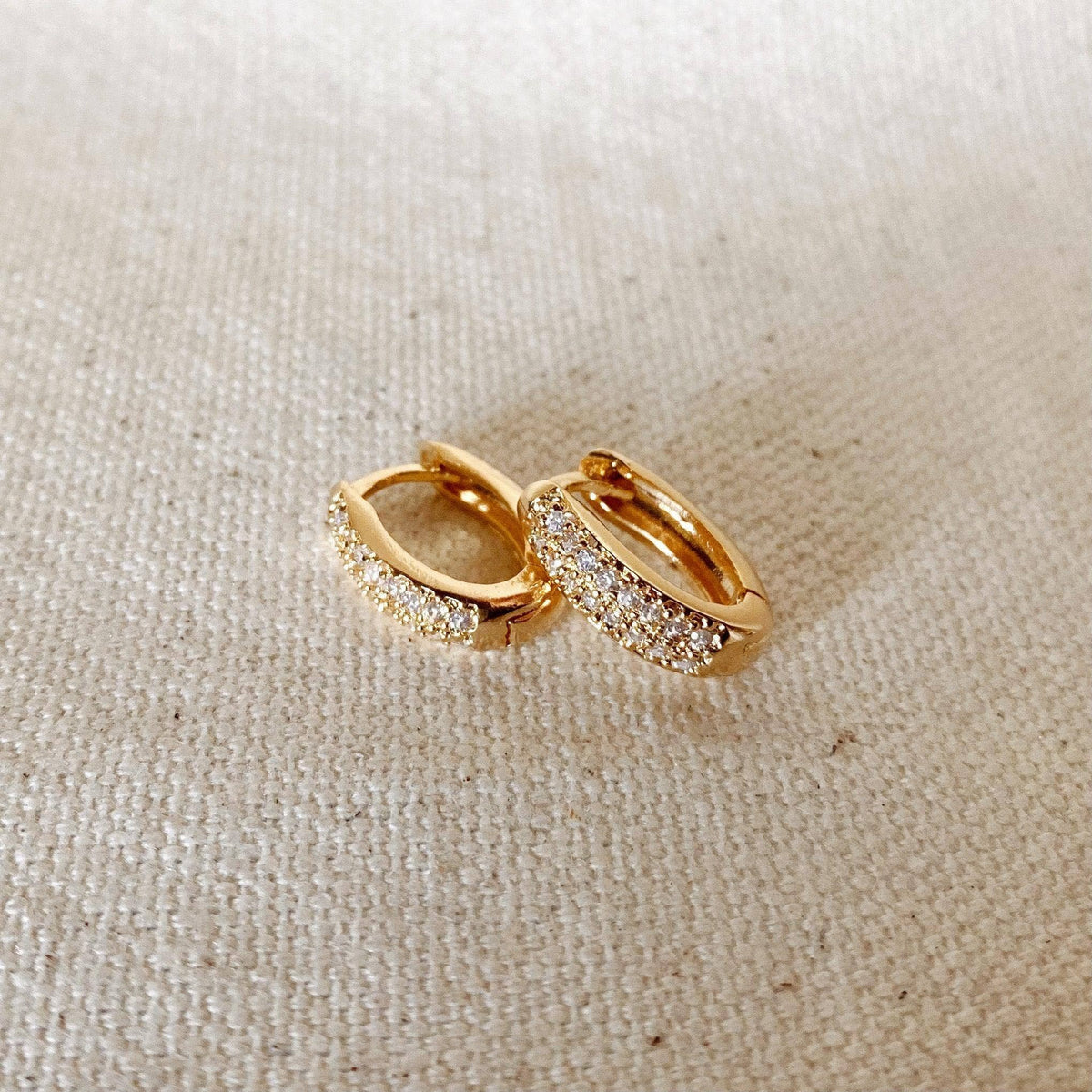 Pavé oval huggie hoops in gold filled on linen