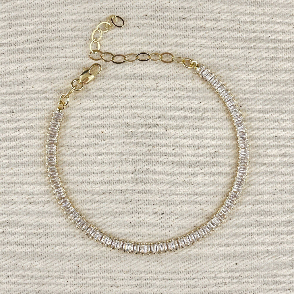 Gold filled baguette tennis bracelet with extender chain on linen