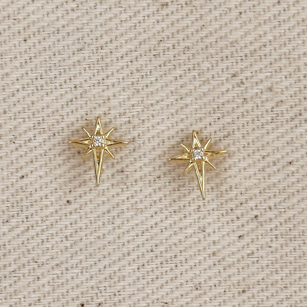 Gold filled starburst stud earrings on linen