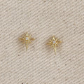 Gold filled starburst stud earrings on linen