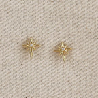 Gold filled starburst stud earrings on linen