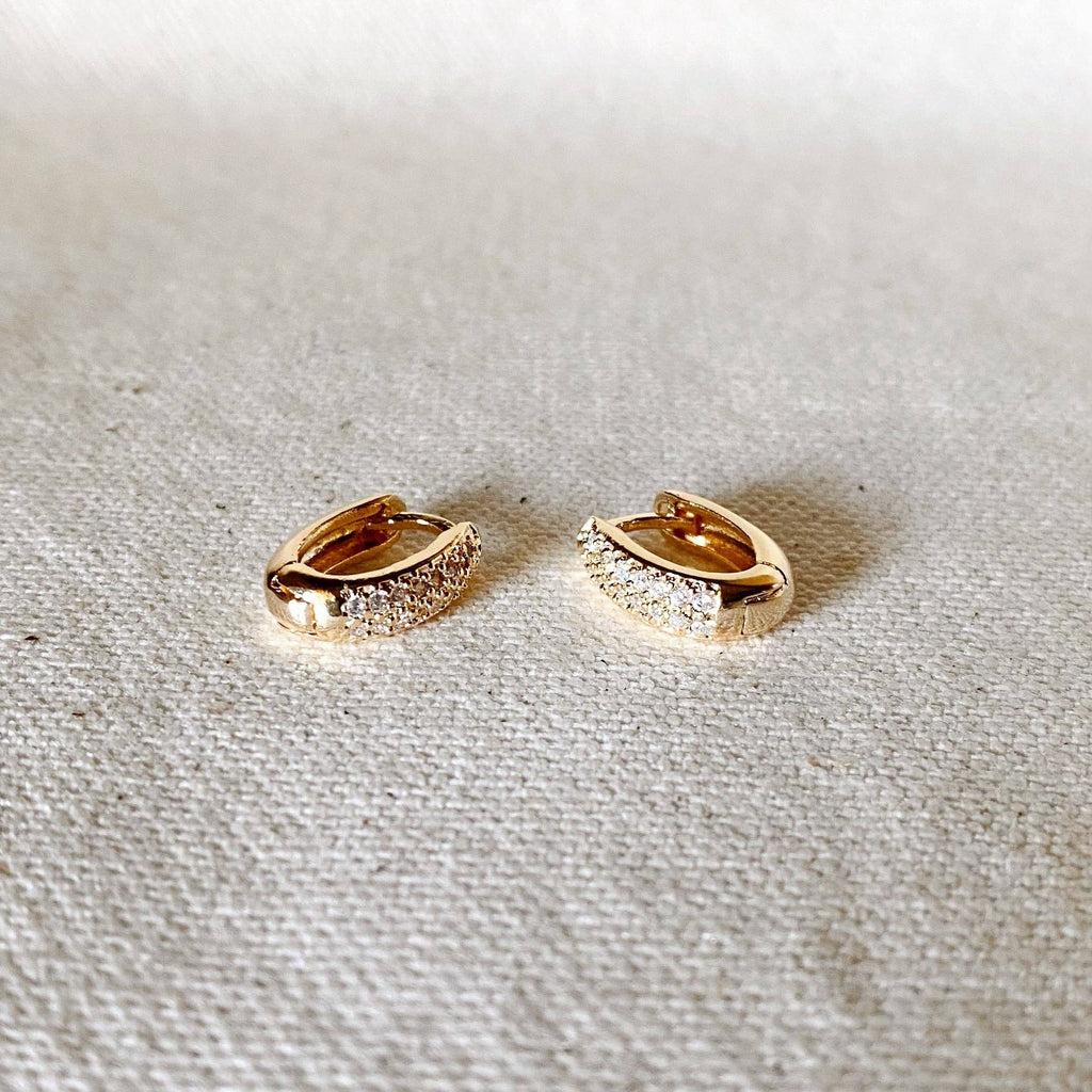 Gold oval pavé hoops on linen