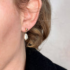 Baroque pearl drop earring worn on the ear