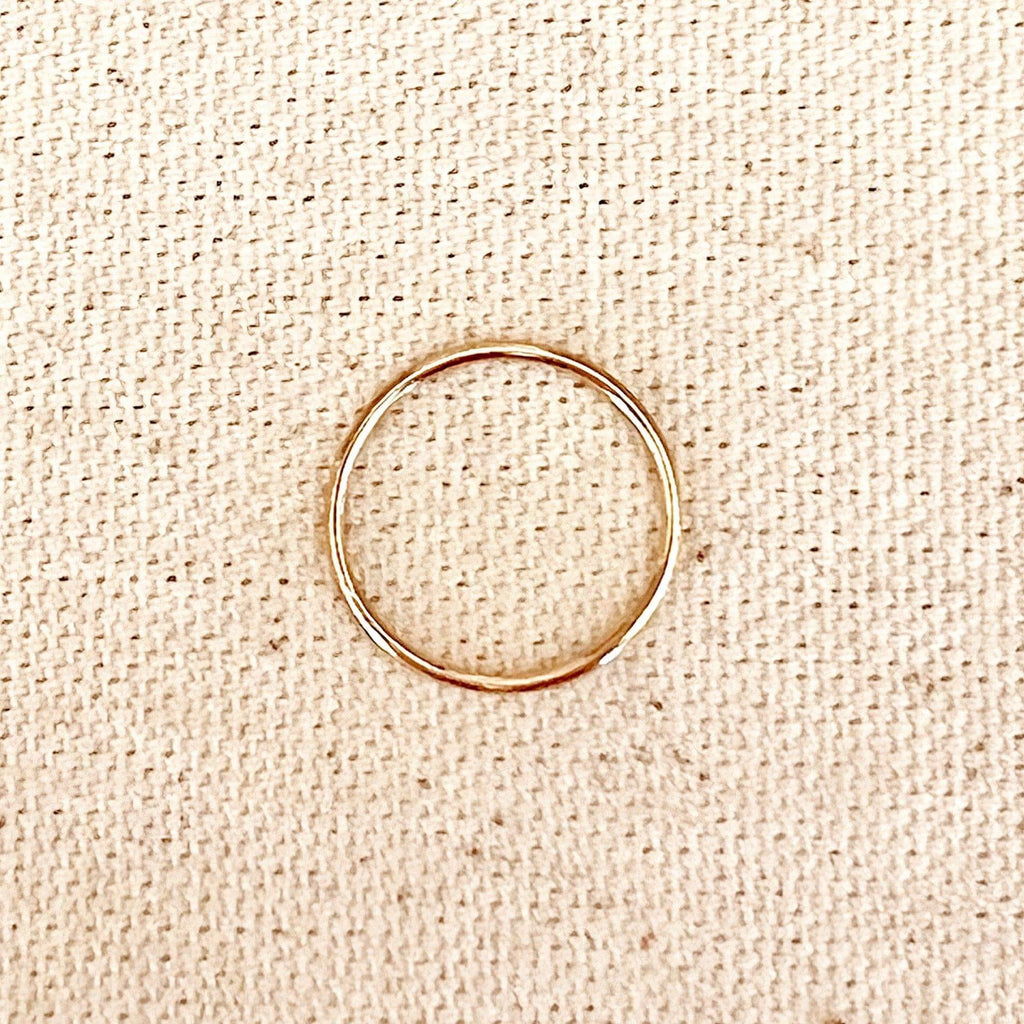 Thin gold filled band ring on linen