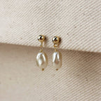 Gold filled pearl drop earrings on a linen edge