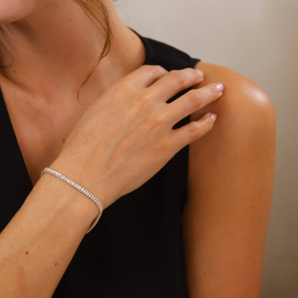 Gold baguette cubic zirconia tennis bracelet on a model