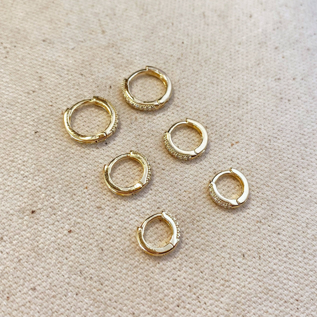 Set of gold pavé hoop earrings on linen
