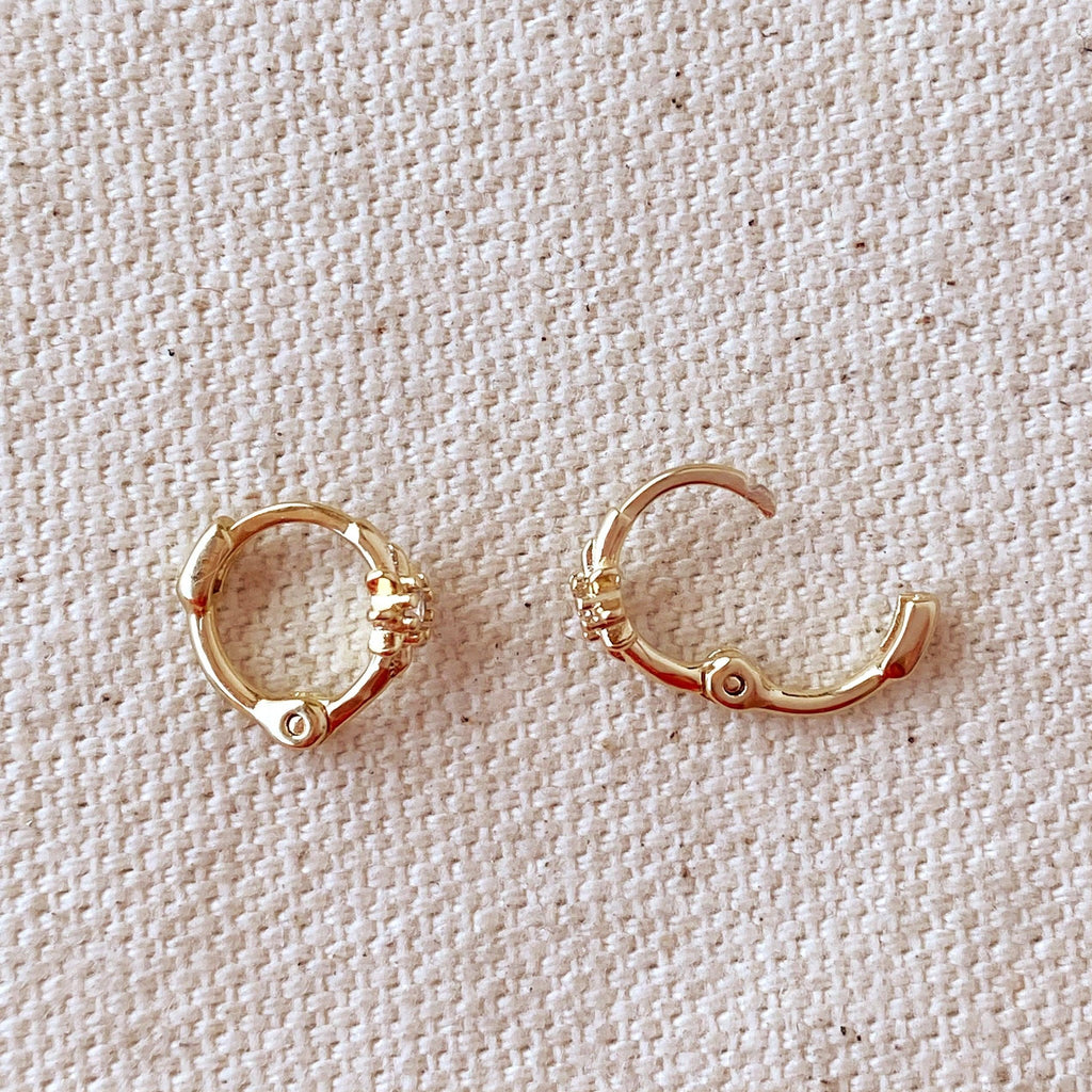 Open clicker huggie hoops with starburst detail