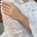 Gold leaf charm bracelet styled on the wrist