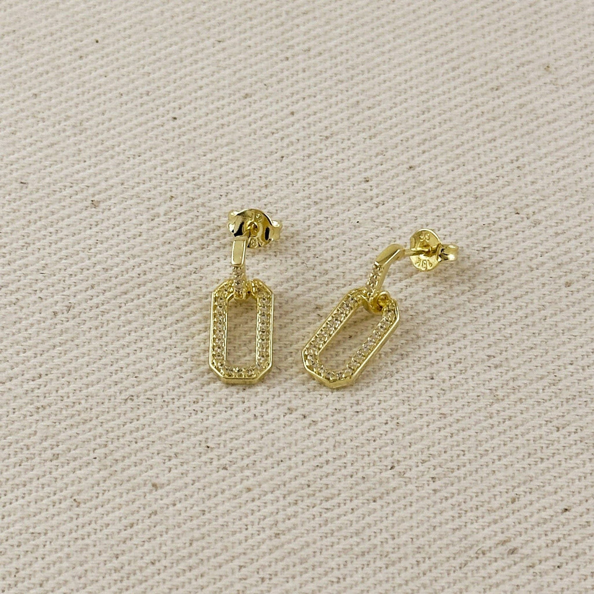 Pavé and polished link earrings on linen