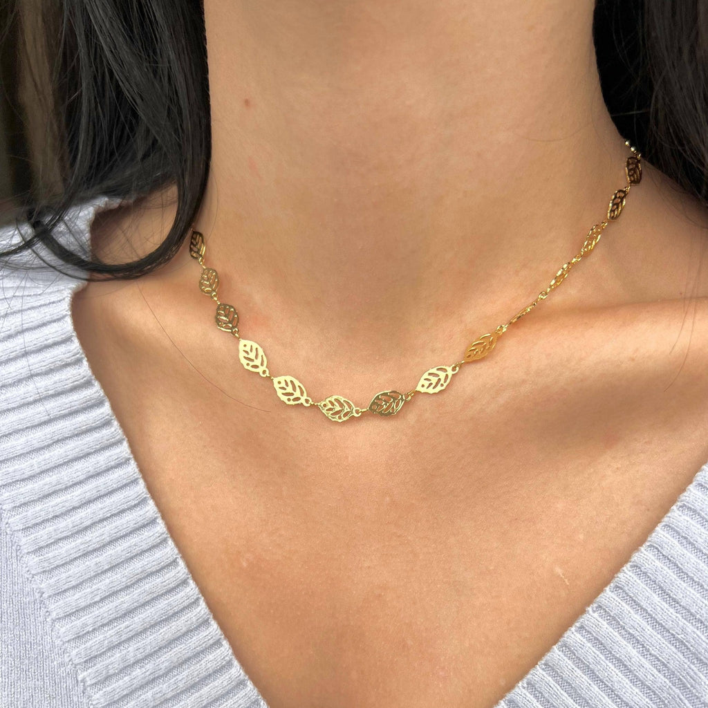 Gold leaf chain necklace styled with a grey knit
