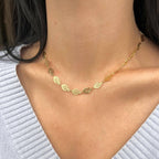 Gold leaf chain necklace styled with a grey knit