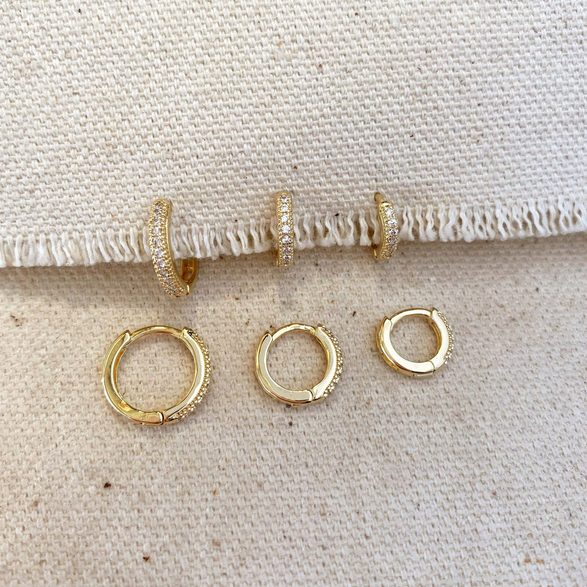 Three sizes of pavé hoops on a linen edge