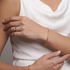 Gold paperclip chain bracelet styled with a white top
