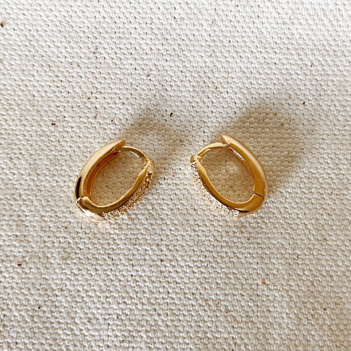 Pair of oval huggie hoops on linen