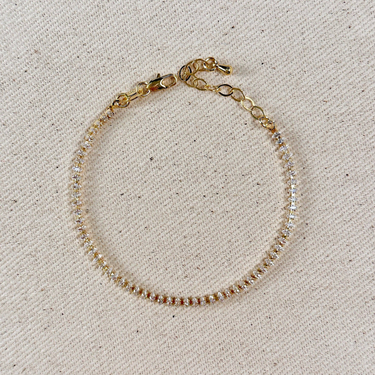 Gold filled marquise tennis bracelet with extender chain on linen