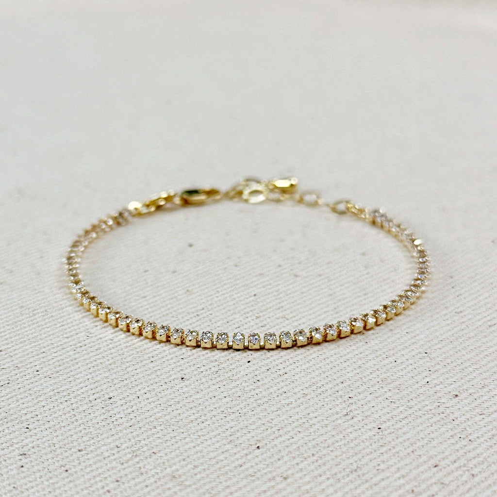 Gold marquise cubic zirconia tennis bracelet on linen