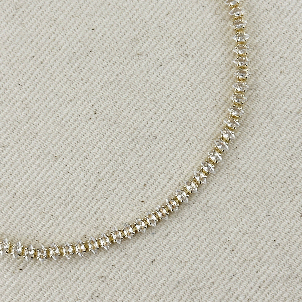 Close up of marquise-cut stones on a gold tennis necklace
