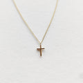 Petite cross necklace in 9ct yellow gold on a fine chain
