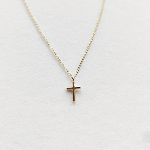 Petite cross necklace in 9ct yellow gold on a fine chain