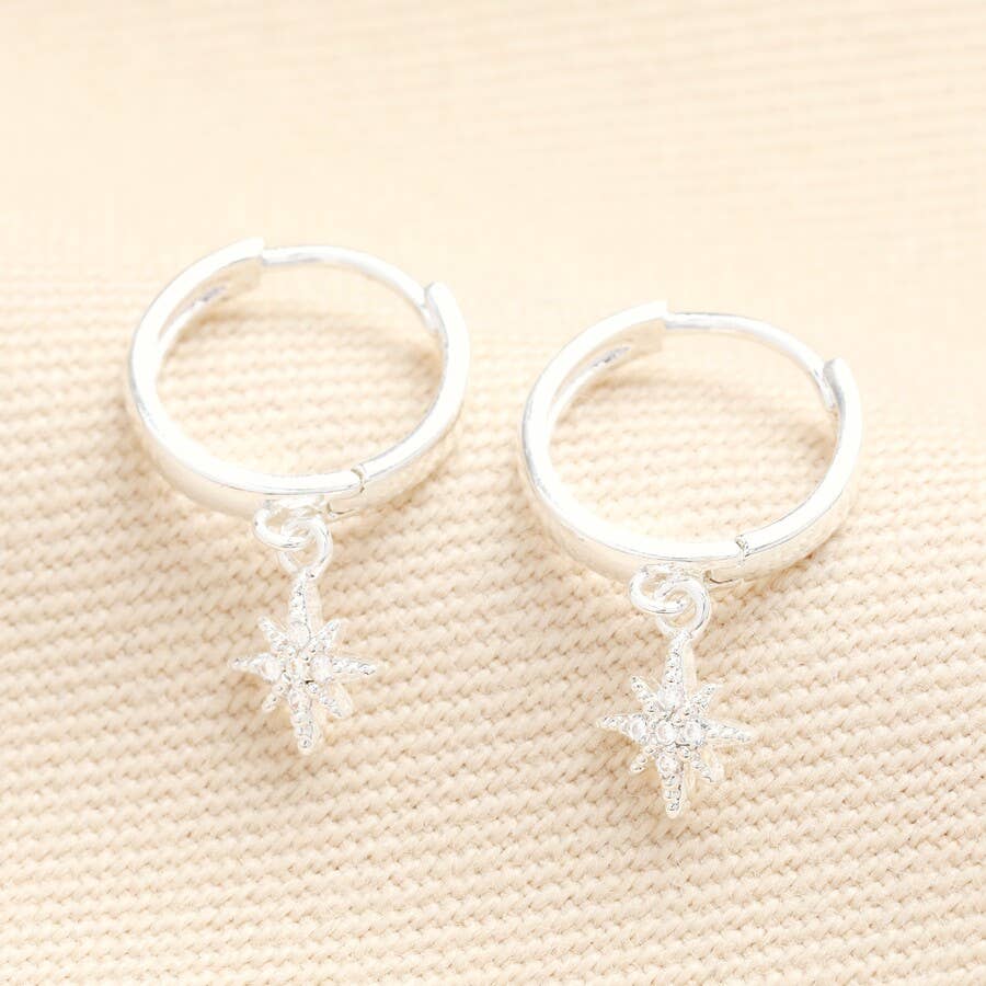 Silver huggie hoop earrings with tiny crystal star charms