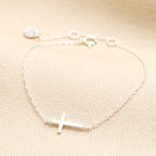 Sterling silver sideways cross bracelet on a fine cable chain