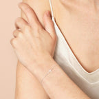 Sterling silver cross bracelet styled on the wrist