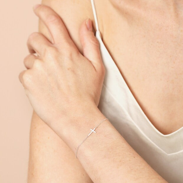 Sterling silver cross bracelet styled on the wrist